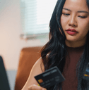 Woman looking at two credit cards