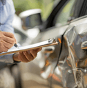 Car insurance adjuster evaluating accident