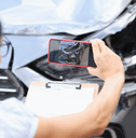 Car insurance adjuster taking photo of accident