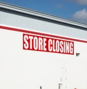 Store closing sign on building