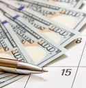 pen with money on a calendar