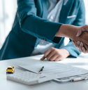 Car insurance agent shaking hands over contract