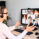 Woman working from home having a zoom meeting with several people