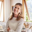 Happy woman standing in kitchen
