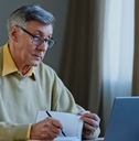 Mature man with laptop and notebook