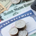 Social Security card with government check, cash, and a calculator