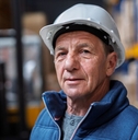 Mature warehouse worker with helmet