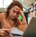 Woman looking stressed over finances