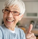 An older woman with a thumbs up