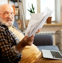 Senior with a lot of paperwork 