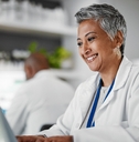 Woman smiling while working at a lab
