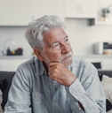 Contemplative older man on couch