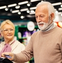 Elderly couple paying at the grocery store