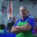 Older supermarket manager with crossed arms