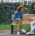 Older couple playing chess on bench