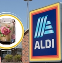 Aldi store sign with floral glass candle