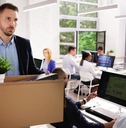 Man fired and holding box walking out of the office