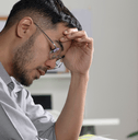 Man looking stressed at computer