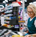 Senior woman working as a cashier 