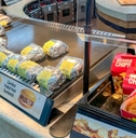 Buc-ee's food court display featuring wrapped sandwiches and Beaver Chips
