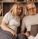 Couple using laptop at home