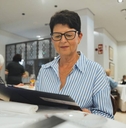 senior woman is sitting at a restaurant table
