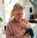 Woman with smartphone looking concerned