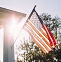 American flag on home with sun in background