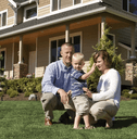 Family in front of new home