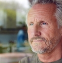 Pensive looking mature man looking out window