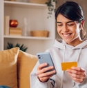 Woman using credit card on cell phone 2