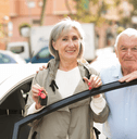 Couple in their 60s with car