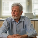 Contemplating older man in kitchen 