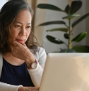 Older woman at home on laptop