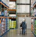 Older woman shopping down a Costco aisle
