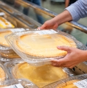Woman grabbing Costco pie