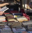 People looking for a book in a vintage market
