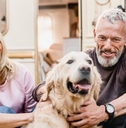 Couple in their 60s petting a dog