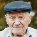Portrait of an elderly man wearing a cap