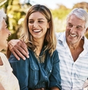 Senior parents smiling with adult daughter