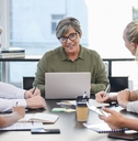 Mature business woman leading meeting