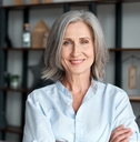 Mature woman smiling with arms crossed
