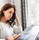 Concerned mature woman looking at paper