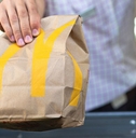 McDonald's bag being handed through the drive thru window