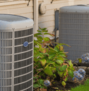 A row of new air conditioning units behind townhomes