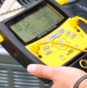 Air conditioning repair man testing unit