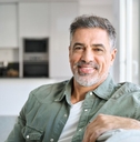 Smiling mature man in a green shirt