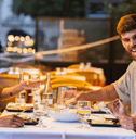 Friends enjoying dinner on restaurant patio