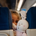 Child peeking between seats on airplane