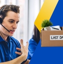 Telephone operator with box of office supplies 